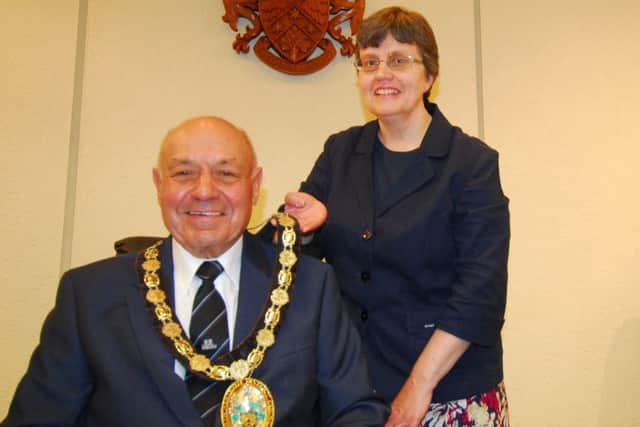 Coun Geoff Hazelwood accepts the chairman's chain of office from outgoing chairman Coun Sally Tarry. EMN-180518-121606001