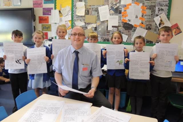 Sleaford Standard News Editor Andy Hubbert with some budding young newshounds at St Botolph's School, Quarrington. EMN-180523-163856001