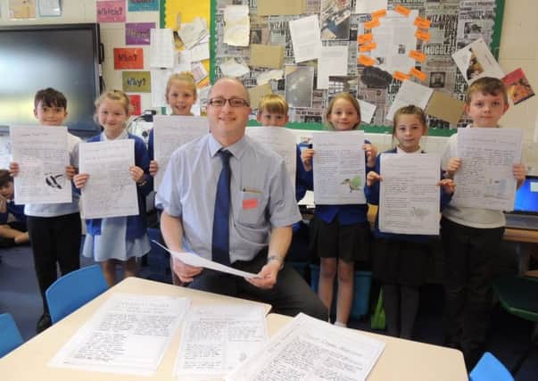 Sleaford Standard News Editor Andy Hubbert with some budding young newshounds at St Botolph's School, Quarrington. EMN-180523-163856001