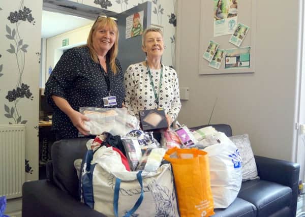 Womens Aid manager Denise and volunteer Jean with some of the items donated EMN-180523-114706001