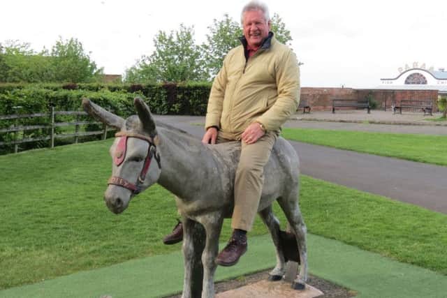 Rotarian Harold Bates found a donkey to ride on EMN-180106-164049001