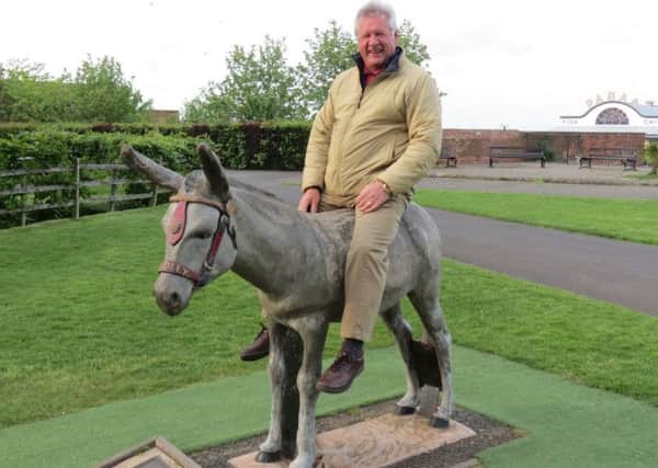 Rotarian Harold Bates  found a donkey to ride on EMN-180106-164049001