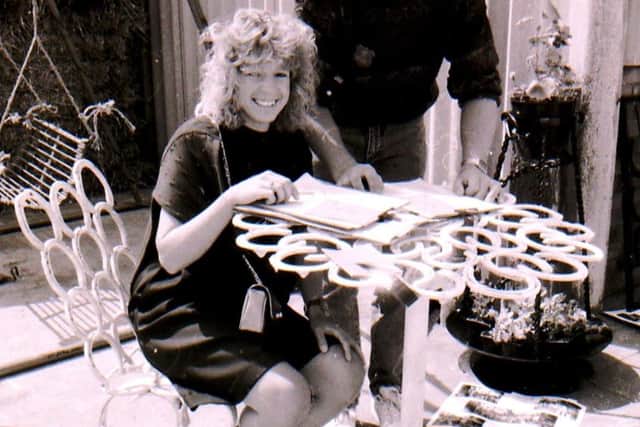Sleaford YFC member Julie Duffin sat at a table and chair made from horseshoes for the items for the garden from new or recycled materials class. EMN-180406-142044001