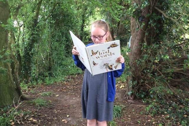 A pupil from St Margaret's School in Withern reads the book. Image supplied.