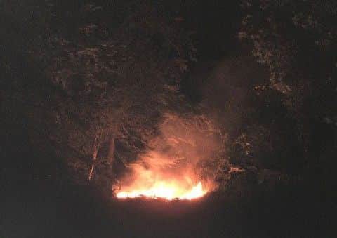 The burning remains of the rain shelter on Monday evening.