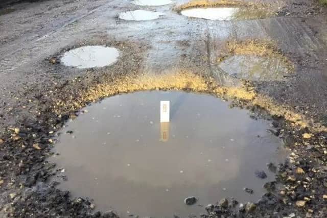 One of the potholes in Broom Covert Lane. EMN-180506-103025001