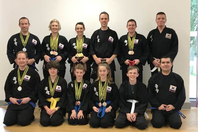 Kuk Sool Won members show off their medals.