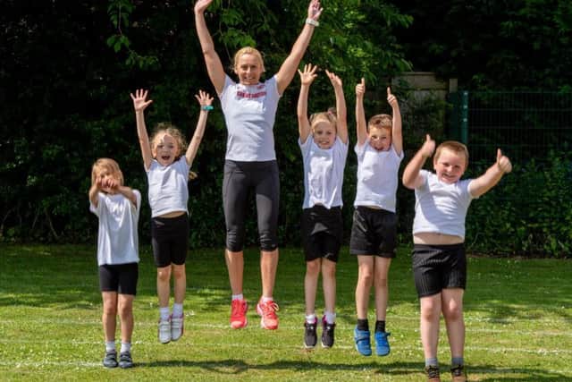 Jenny Meadows jumps for joy with pupils from Horncastle Community Primary School