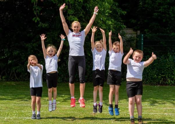 Jenny Meadows jumps for joy with pupils from Horncastle Community Primary School