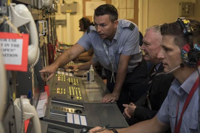 Squadron Leader Kinniburgh showing Mr Clarke an ATC system.