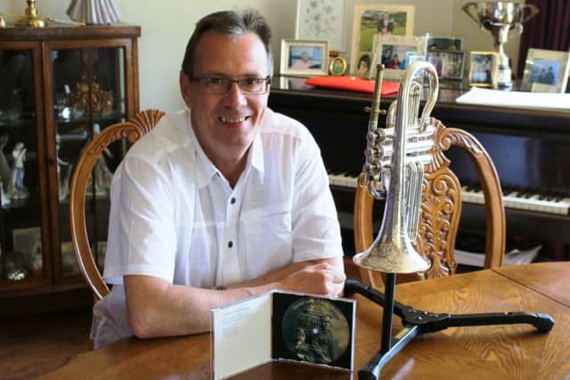 Brian Harper, pictured with the special 135-year-old cornet that was used to produce the charity CD.