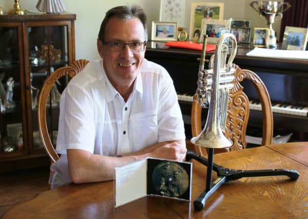 Brian Harper, pictured with the special 135-year-old cornet that was used to produce the charity CD.