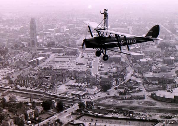 Dawn Ross of Ruskington on her flight over Boston strapped to the wing of a Tiger Moth in 1983. EMN-180615-162908001