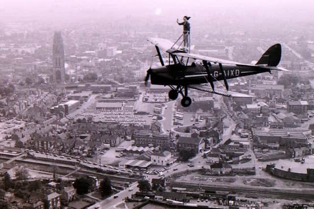 Dawn Ross of Ruskington on her flight over Boston strapped to the wing of a Tiger Moth in 1983. EMN-180615-162908001