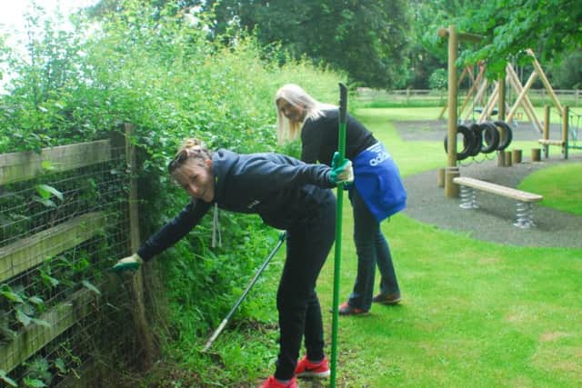 Sleaford and Metheringham Co-op staff at work on the play park in Swaton. EMN-180615-094104001