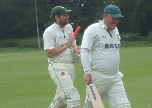 Ian Williams (right) and Neil Davies walk off at the end of the record-breaking innings EMN-180618-155541002