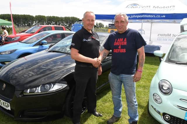 Drivers 4 Defib family fun day. Neil Donner (right) with John Peat Motors salesman Chris Shaw . EMN-180625-143359001