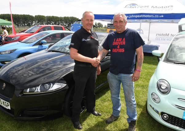 Drivers 4 Defib family fun day. Neil Donner (right) with John Peat Motors salesman Chris Shaw . EMN-180625-143359001