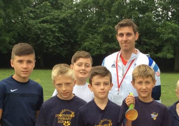 GB athlete Richard Buck with Osbournby School children. EMN-180622-114303001