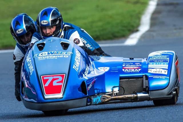 Sidecar passenger Jev Walmsley and Pete Founds negotiate the iconic road circuit at the Isle of Man TT EMN-180625-144928002