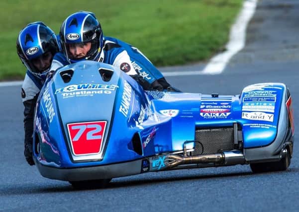 Sidecar passenger Jev Walmsley and Pete Founds negotiate the iconic road circuit at the Isle of Man TT EMN-180625-144928002