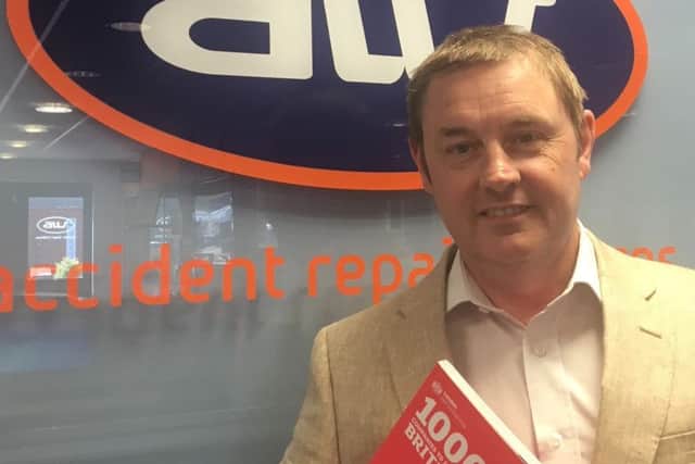 Andrew Walsh, proud Managing Director of AW Repair Group, holds the 1,000 Businesses To Inspire Britain directory which includes the Sleaford-based company.