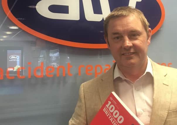 Andrew Walsh, proud Managing Director of AW Repair Group, holds the 1,000 Businesses To Inspire Britain directory which includes the Sleaford-based company.