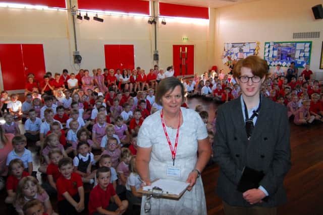 Reader Sara Davies with Cameron Macadam talk about his mission to Chestnut Street School pupils in Ruskington. EMN-180307-115801001