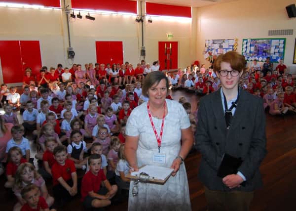 Reader Sara Davies with Cameron Macadam talk about his mission to Chestnut Street School pupils in Ruskington. EMN-180307-115801001