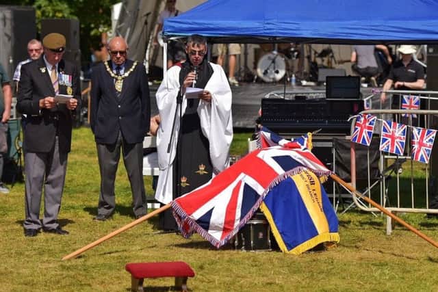Rev Phillip Johnson leads the drumhead service on the recreation ground during NK Fest on Sunday. EMN-180307-002618001