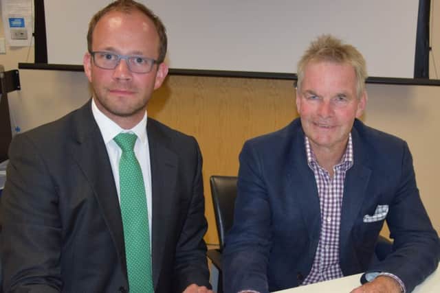 Coun Matthew Lee (left) and Councillor Martin Hill sign the letter to United Lincolnshire Hospitals Trust and South West Lincolnshire Clinical Commissioning Group. EMN-180207-182507001