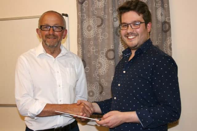 David Boorer hands over the baton to Josh Wilkinson. Image supplied.