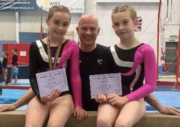Club coach Edward Shields with Lucy Rudd (left) and Scarlott Field were third and fifth at the County Level 4 gymnastics EMN-180507-084551002