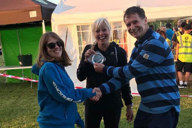 Janine Stones receives her prize for as senior/veteran woman's winner in the Lincolnshire Runner Cross Country (XC) League
by Lincolnshire Runner sponsors and her coach, Malcolm Brine (right). EMN-180507-102956002