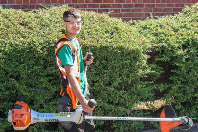 Operative Charlie Smith with a labelled strimmer.