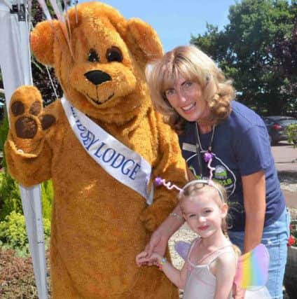 Four-year-old Pippa Lawrence is pictured meeting Lindsey Bear and Lindsey Lodge Hospice Chief Executive Karen Griffiths. EMN-180707-091125001