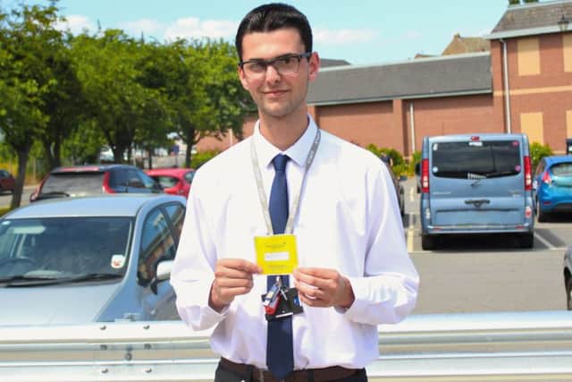 WLDC employee Luke Nelson with his parking permit. EMN-180907-132001001