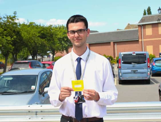 WLDC employee Luke Nelson with his parking permit. EMN-180907-132001001