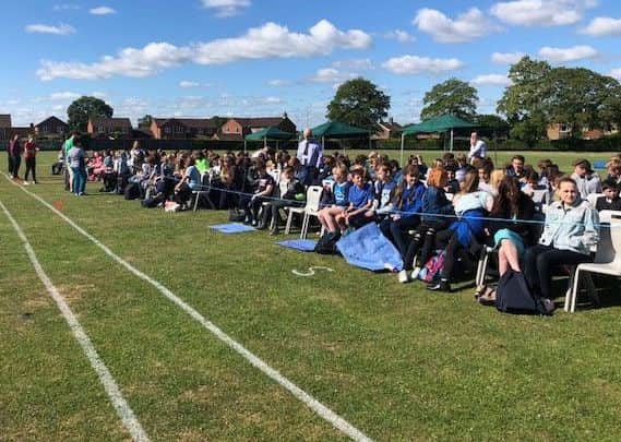 Spectators line the track at the sports day where a number of records were set