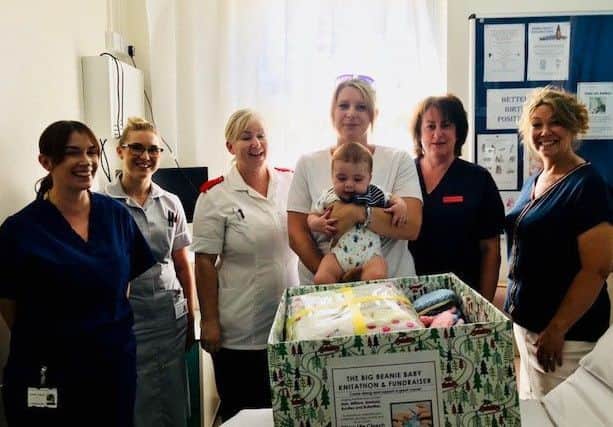 Linzi Spoor donating a load of knitted bonnets and items to Boston Pilgrim Hospital. EMN-180716-134225001