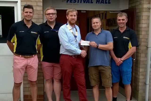 Market Rasen Round Table chairman Paddy Cameron handed the cheque to Youth Club  treasurer Bruce Davies, watched by Round Table members. EMN-180723-150015001