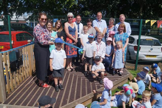 Reception teacher Hannah Rddell officially opened the new play area watched by the children and some of those who had contributed. EMN-180713-222344001