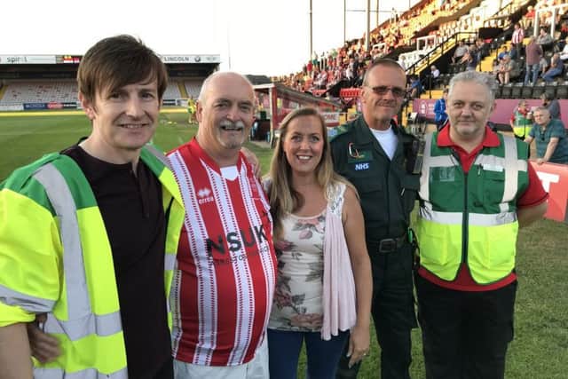 From left - Paramedic Garry Duckett, Michael Bull, Paramedic Kirsty Doyle, Emergency Care Assistant Taff Powell and Paramedic Adrian Doughty at Lincoln City FC. EMN-180713-125308001