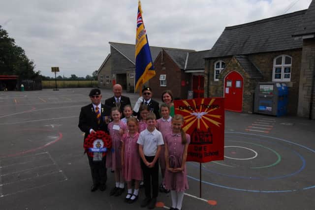 Alan Robbins, Clive Candlin, Brian Harvey, headteacher Katie Gravel and Kirkby la Thorpe with the poppy wreath and message written by pupil Alexandra Leeson, aged nine, that will be laid at the Menin Gate memorial. EMN-180716-002847001