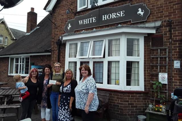The White Horse presents ?719 raised to Rainbow Stars support group. Pictured at the presentation at the pub are, from left - Sally Preston (landlady) Jane Peck, Hannah Owen, Tara Ward Jones and Kath Thompson.
Photo supplied. EMN-180720-144834001
