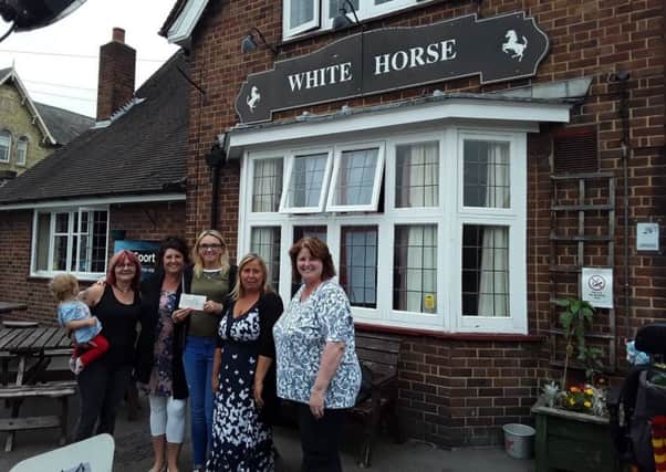 The White Horse presents ?719 raised to Rainbow Stars support group. Pictured at the presentation at the pub are, from left - Sally Preston (landlady) Jane Peck, Hannah Owen, Tara Ward Jones and Kath Thompson.
Photo supplied. EMN-180720-144834001