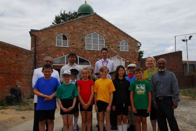 Teachers and pupils from Church Lane and Heckington schools with members of Sleaford Islamic Centre outside their new mosque opposite the station. EMN-180720-120408001
