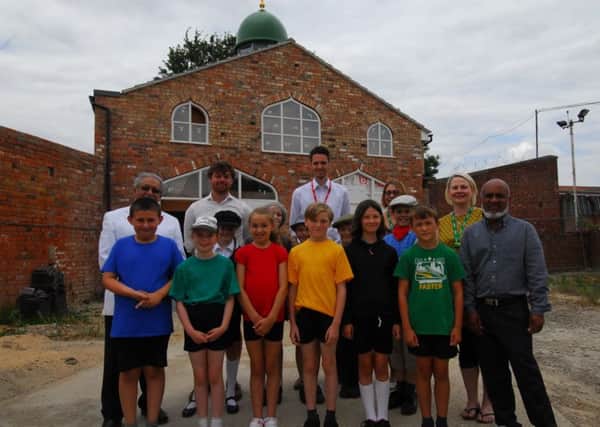 Teachers and pupils from Church Lane and Heckington schools with members of Sleaford Islamic Centre outside their new mosque opposite the station. EMN-180720-120408001