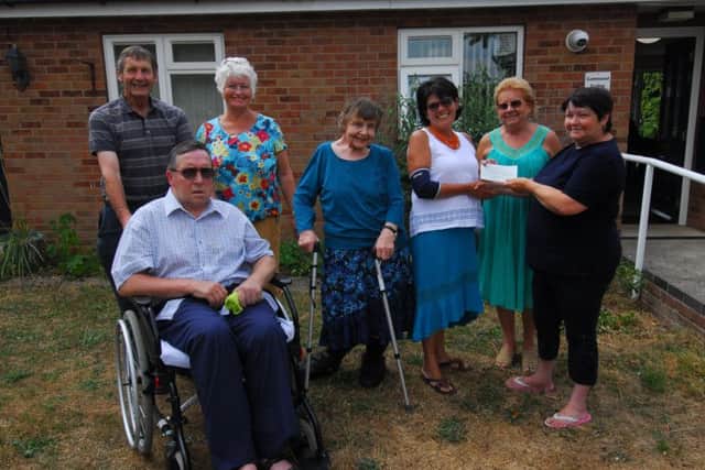 Presenting a donation of ?250 raised from a coffee morning at Greenfield Community Centre to Sleaford Dementia Support Group. From left - John Maddison (trustee of the support group), Steve Bowler, Kay Birchnall (trustee of the support group), Pearl Hornby (community centre treasurer), Jackie Coburn (support group chairman), Linda Goodge (community centre secretary) and Jackie Coburn (community centre chairman). EMN-180720-141257001