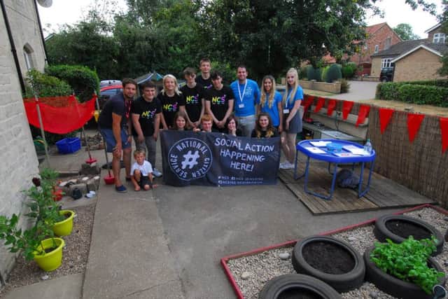 NCS teenagers show of their finished project, renovating the reception class garden at Kirkby La Thorpe School. EMN-180724-122414001